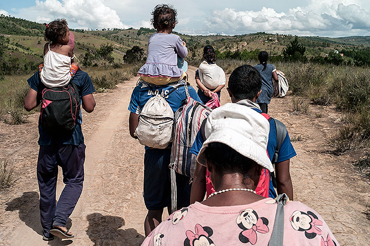 families on foot leaving Antananarivo, the capital of Madagascar