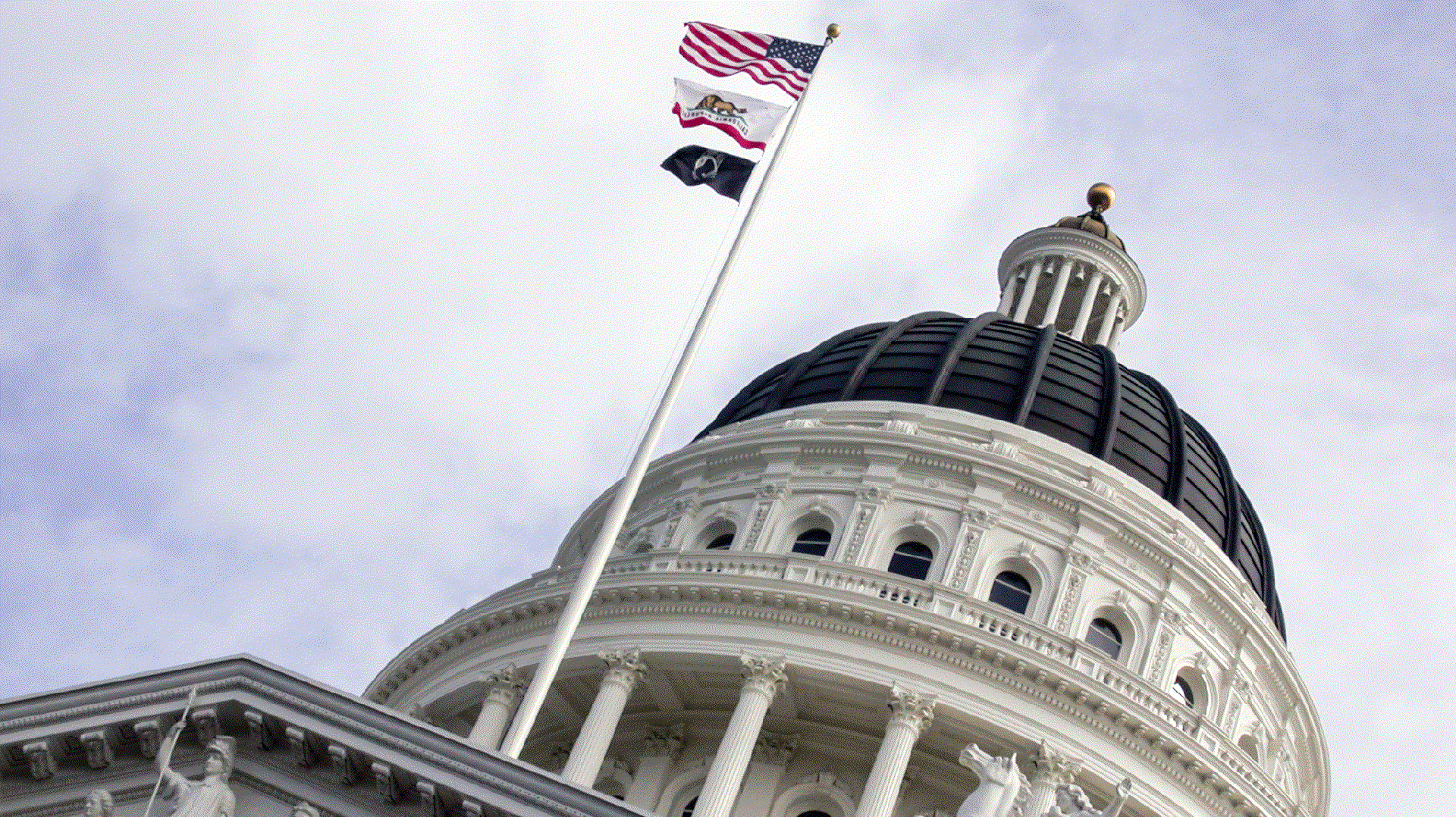 The dome of the California state capitol in Sacramento, with flags