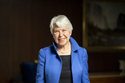 A portrait of Chancellor Christ shows her smiling at the camera weaing a blue jacket.