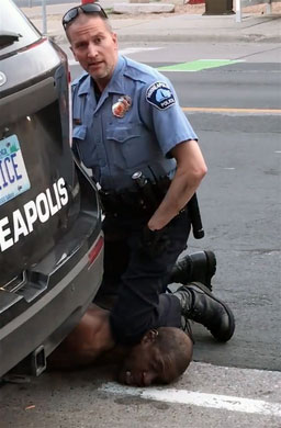 Police Officer Derek Chauvin kneels on the neck of George Floyd during an arrest last year in Minneapolis