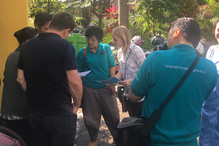 researchers interacting with Indonesian officials during dengue mosquito study