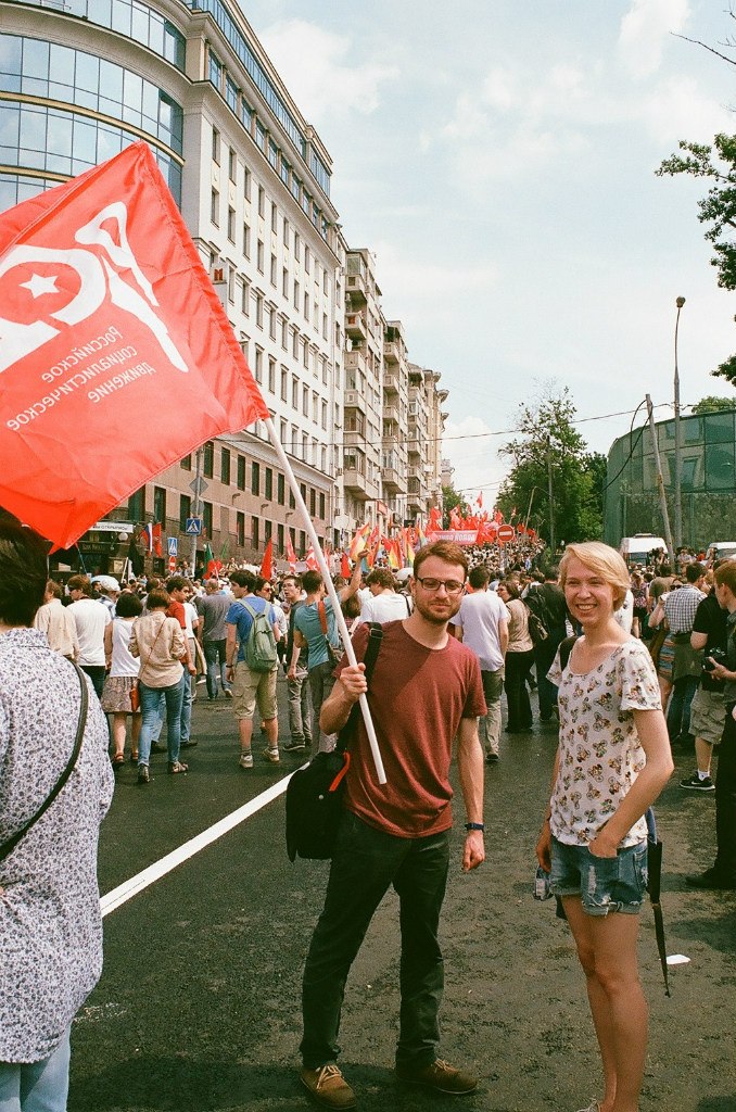 man holding a flag at a workers' rights rally 