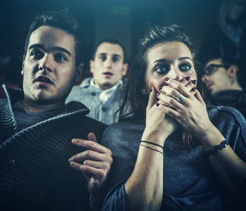 People in movie theater expressing shock