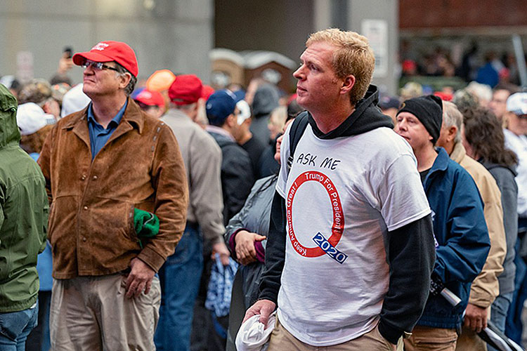 Adherent of the QAnon conspiracy cult awaiting a rally for Donald Trump