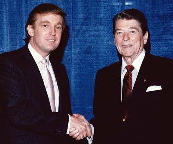 Donald Trump, left, shaking hands with Ronald Reagan in an undated photo.