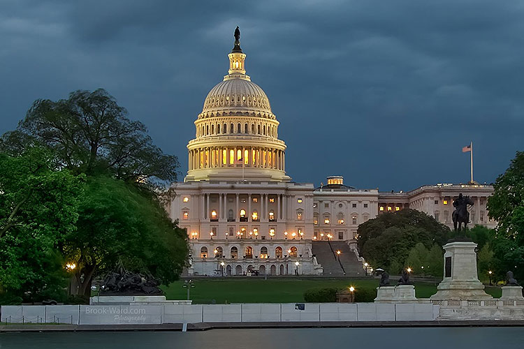 The U.S. capitol dome against a backdrop of dark clouds