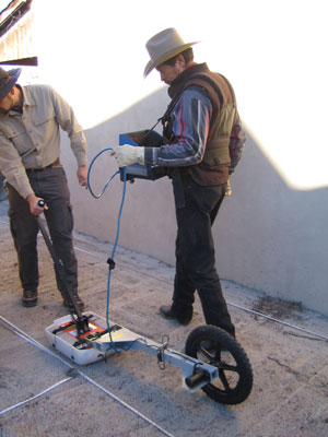 Virgil Trujillo, right, and Jun Sunseri, use a ground-penetrating radar attached to a wheel