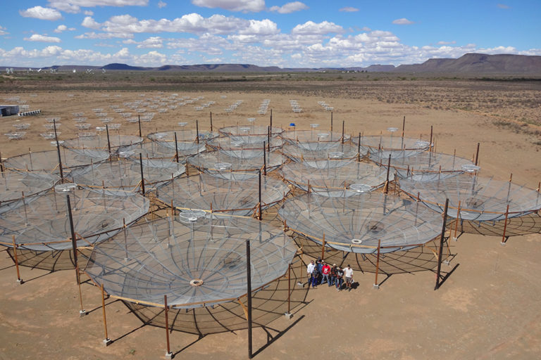 The HERA array in South Africa consisted of 19 dishes on March 7, 2016, but continues to grow, replacing an earlier experiment called PAPER (small dishes in the background). (Images courtesy of the HERA team)