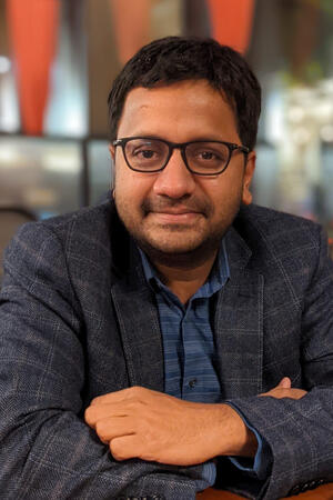 Headshot of Karthik Shekhar in with arms crossed in front of chest