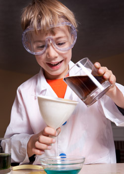 Stock footage of a small boy in a lab coat.