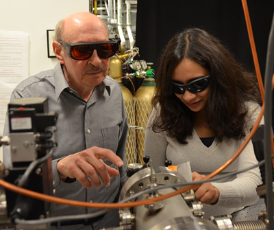 Chemistry professor Stephen Leone and postdoctoral fellow Krupa Ramasesha examine the vacuum chambers of an attosecond laser. (UC Berkeley photo by Robert Sanders)