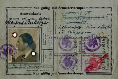 A student ID with profile picture, ink stamps prints, and writing in the German language.
