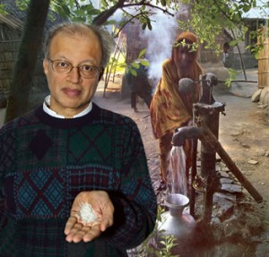 Ashok Gadgil standing in foreground with woman getting water from well in background.
