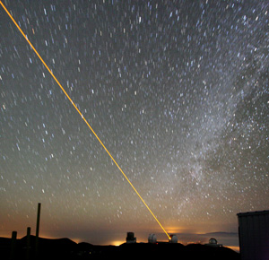 A laser seen against a starry night sky.