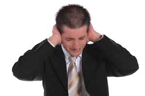Stock photo of A man clutching his ears.