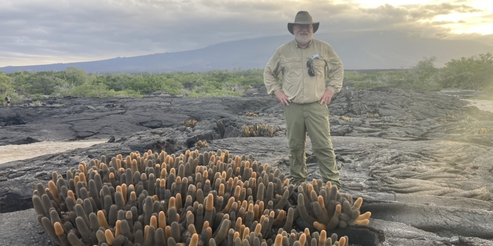 Brent Mishler doing fieldwork on the youngest Galapagos Island, Fernandina, with the endemic lava cactus Brachycereus nesioticus