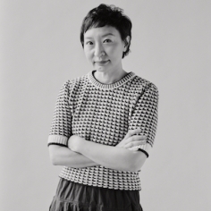 Cathy Park Hong standing with arms crossed as waist