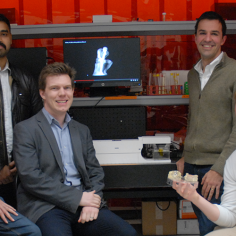 Hayden Taylor (third from left) with group members and collaborators holding components produced by computed axial lithography