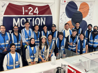 UC Berkeley-affiliated CIRCLES members pose in front of signed I-24 MOTION and CIRCLES banners at the end of testing week. (Photo & Caption Credit: Berkeley News)