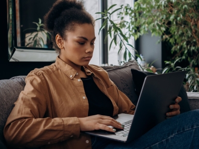image of woman on the couch on her laptop
