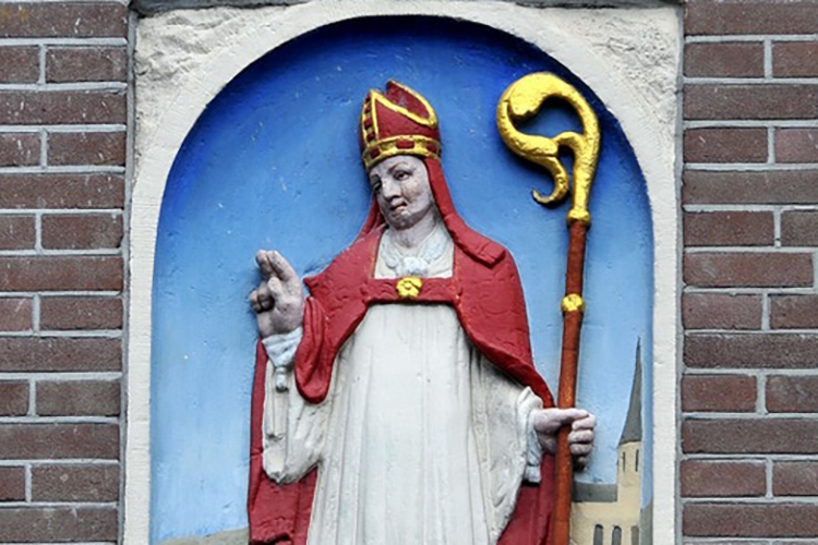 Stone tablet depicting Saint Nicholas with a scepter, and red and white garments depicting a Catholic bishop.