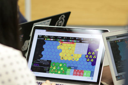A photo of a laptop screen showing the SIGNAL online game