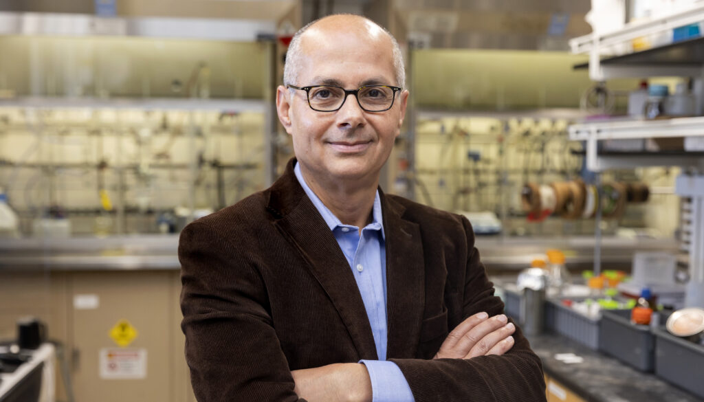 man with arms folded in front in lab setting