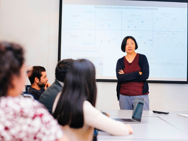 Bin Yu standing at front of classroom with students in foreground