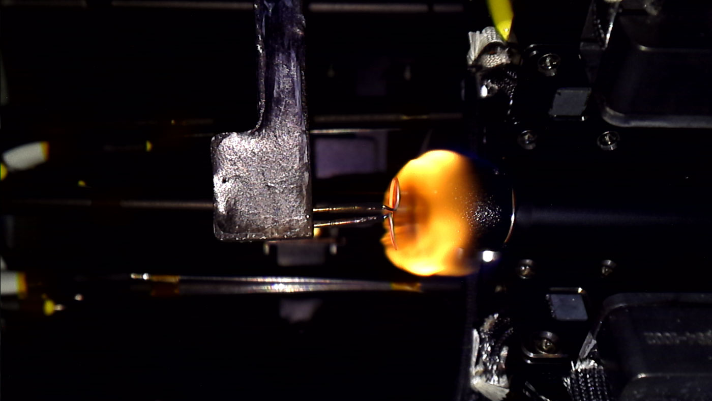 Igniting a 12.7 mm sample at 21% oxygen under 100 kPa ambient pressure in microgravity.