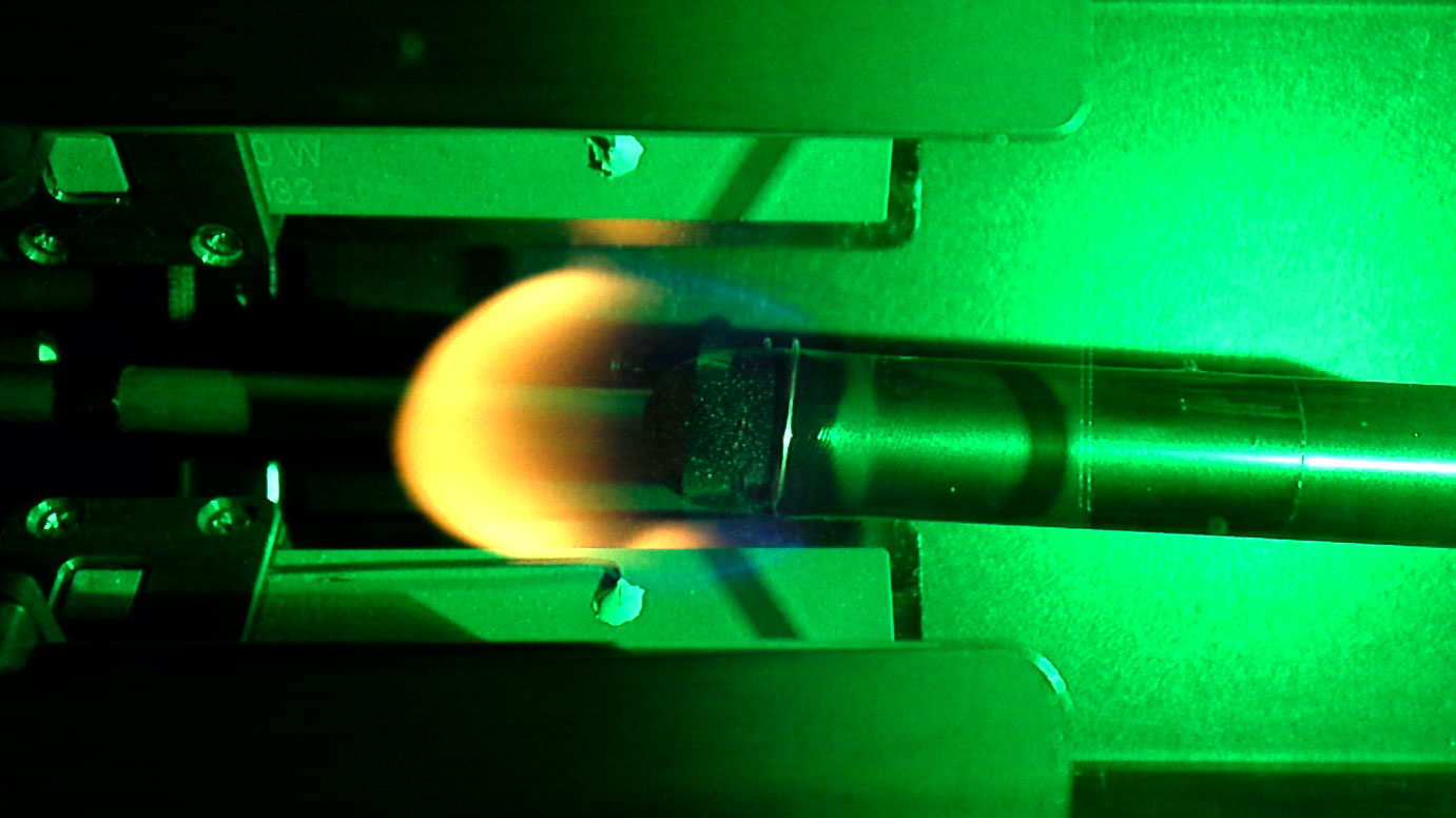 Flame spreading over a 12.7 mm sample at 19.8% oxygen under 60 kPa ambient pressure in microgravity.