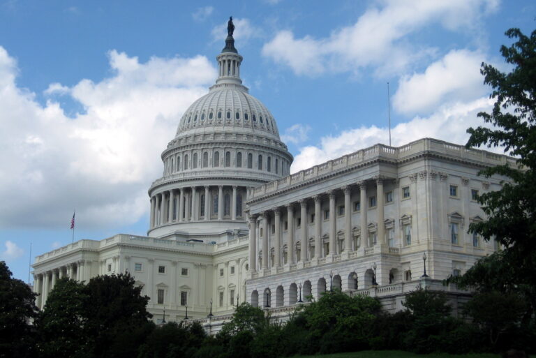 The U.S. Capitol dome against a backdrop of clouds and blue sky