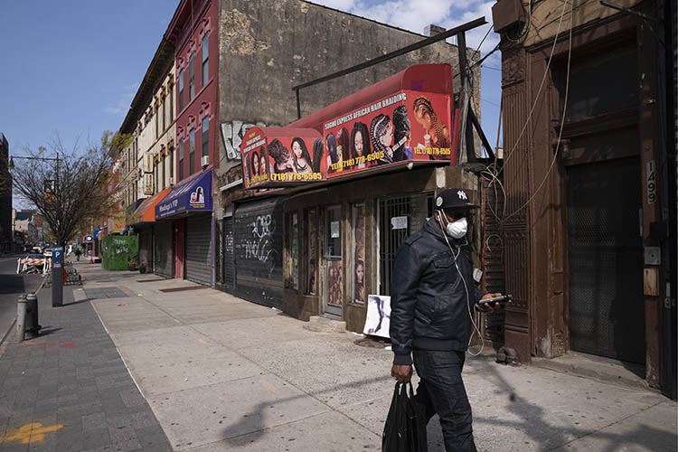 a black man walks down the street in new york city