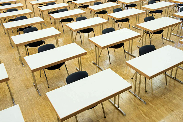 A room full of desks with chairs in rows