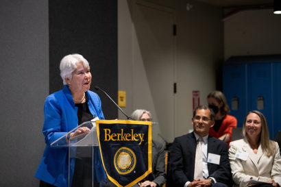 Carol Christ speaking at a podium.