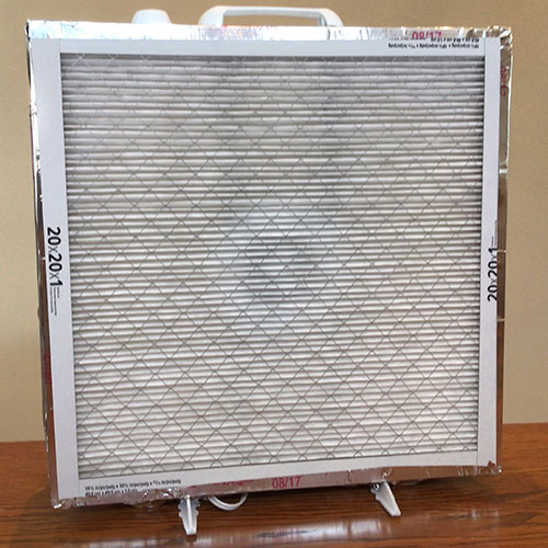 A photo shows a box fan with a furnace filter taped to the front.