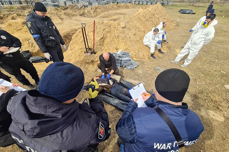 war crimes investigators in Bucha, Ukraine, study bodies exhumed from the site of a mass burial