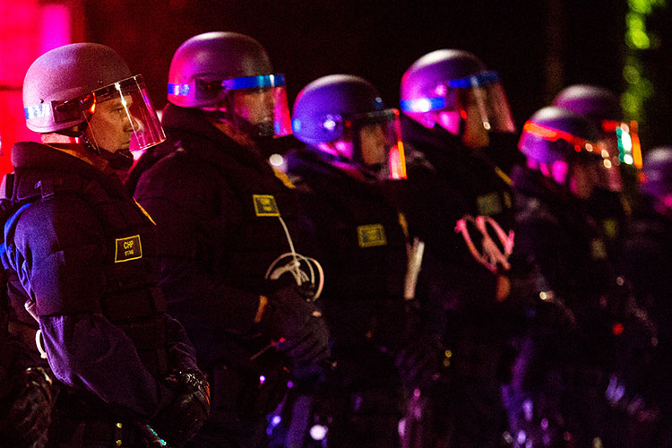 A phalanx of police officers prepared for a night-time demonstration