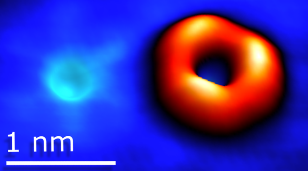 Scanning tunneling microscopy image of an oxygen atom substituting sulfur and a sulfur vacancy in tungsten disulfide.