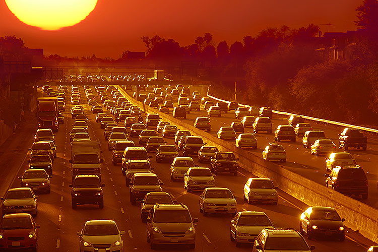 a California freeway traffic jam in ominous orange sunset light