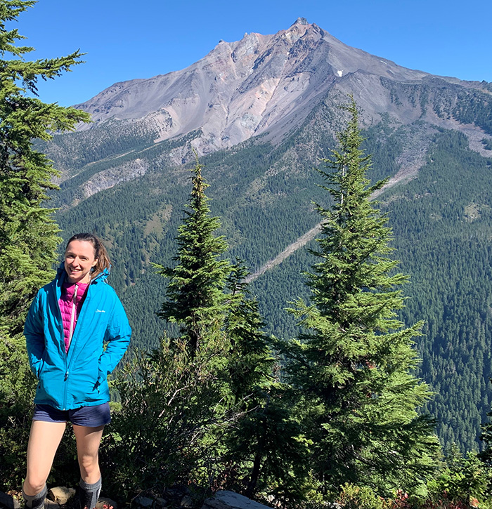 Penny Wieser standing with a Cascade peak in background