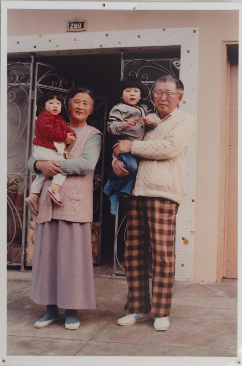 image of a family standing outside their house