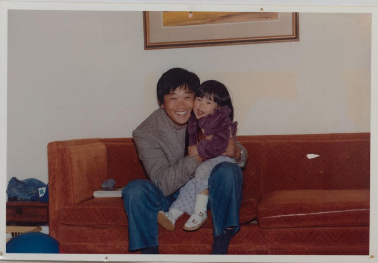 image of a dad holding his daughter on the couch 