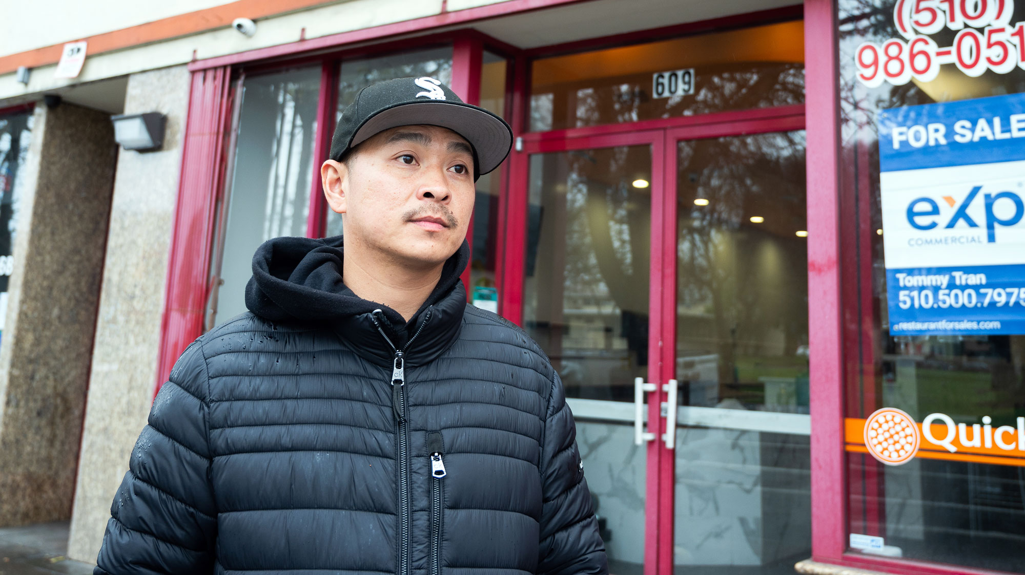 Chien Nguyen standing before an empty storefront in Oakland's Little Saigon neighborhood.