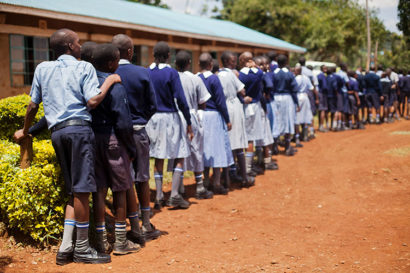 A line of students in Vihiga County, Kenya, wait to receive deworming medication.