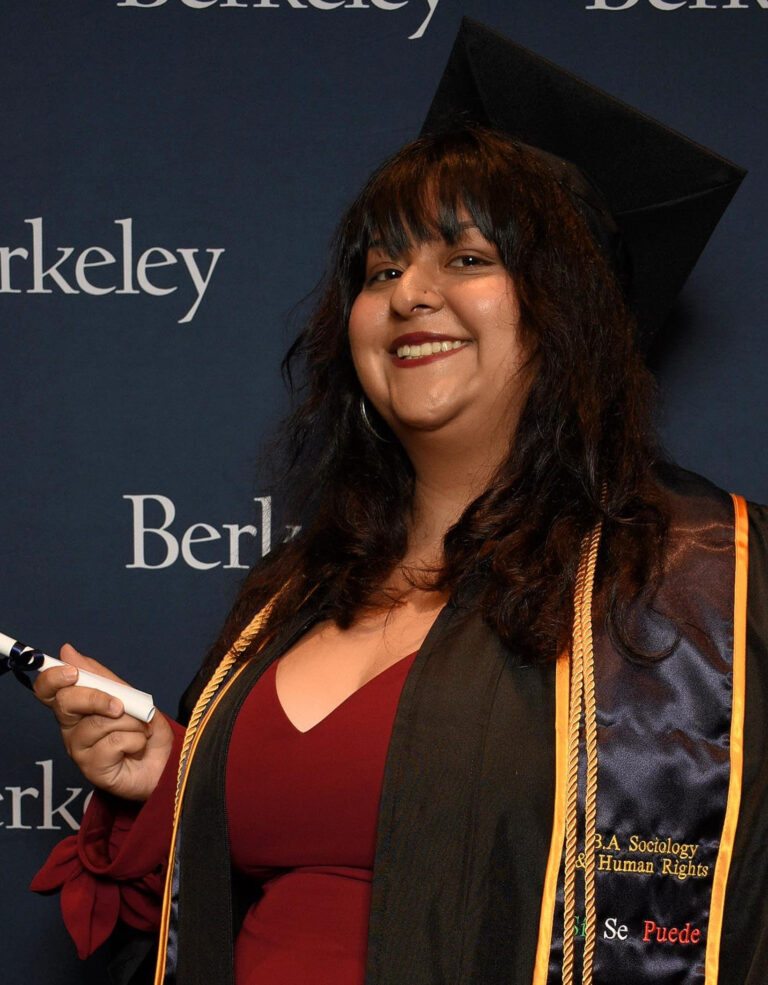 image of woman in graduation cap smiling