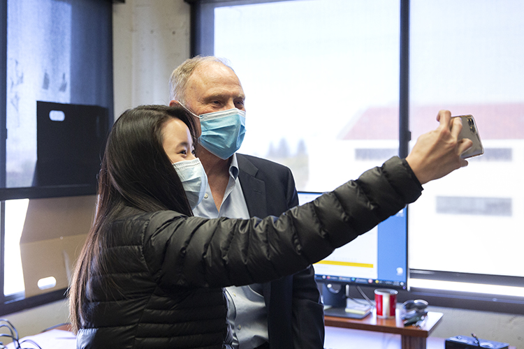 David Card poses for a selfie with a student in his office at the Center for Labor Economics on the day of his 2021 Nobel Prize win.