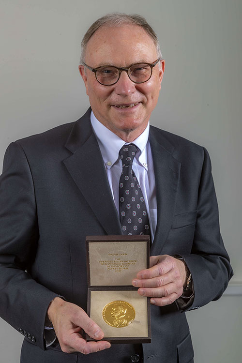 David Card poses with his Nobel Prize medal