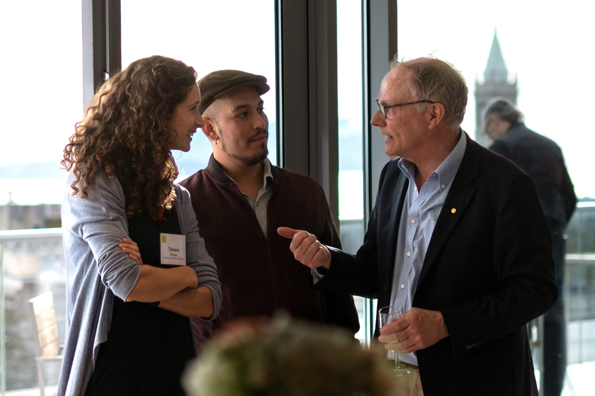 David Card (right), one of the 2021 Nobel laureates in economics, talks with young colleagues during a quieter moment during the two-day event honoring his contributions. While he has made remarkable contributions to the field of labor economics and research methodology, Card is known as well for teaching and mentoring young economists.
