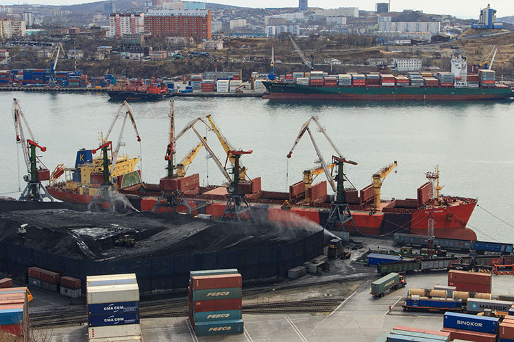 A photo of a port with barges and large shipping containers