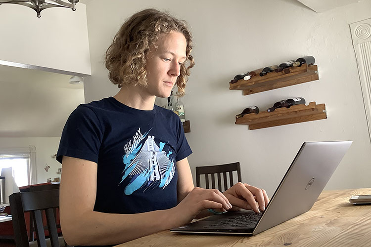 Elise Baker, a recent Berkeley Law graduate, works on her laptop.